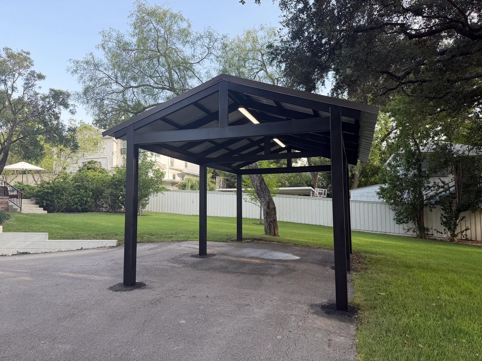 Completed custom black metal carport by JJT Remodeling